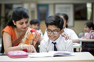 Indian teacher with young male student