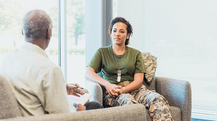 Female solder talks with therapist
