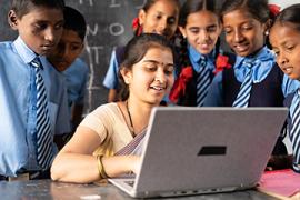 Indian teacher on laptop with students