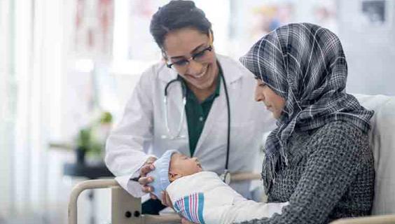 Afghan mother and newborn with doctor
