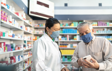 Female pharmacist helping a senior customer