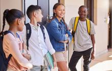 Happy teens by school lockers