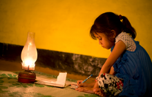 Rural girl studying in lantern light